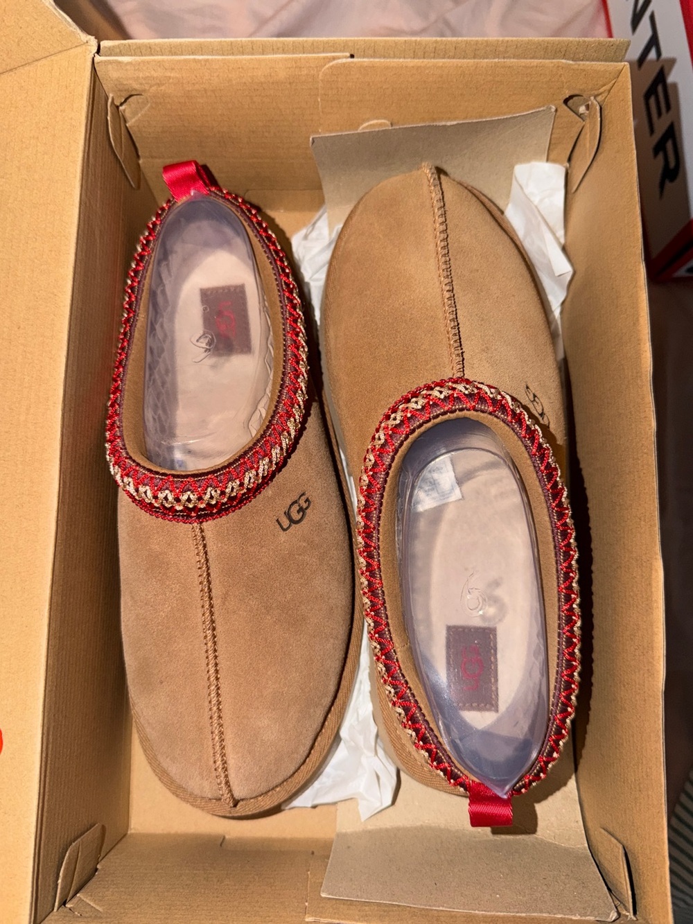 UGG Tan Suede Slip-Ons with Red Trim